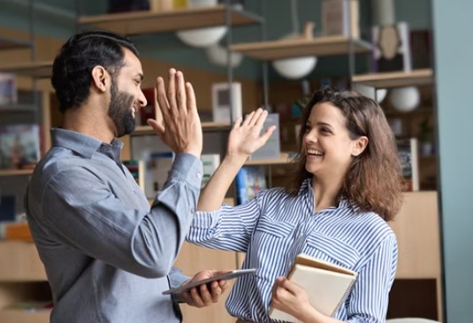 A teacher giving a high five to her student teacher