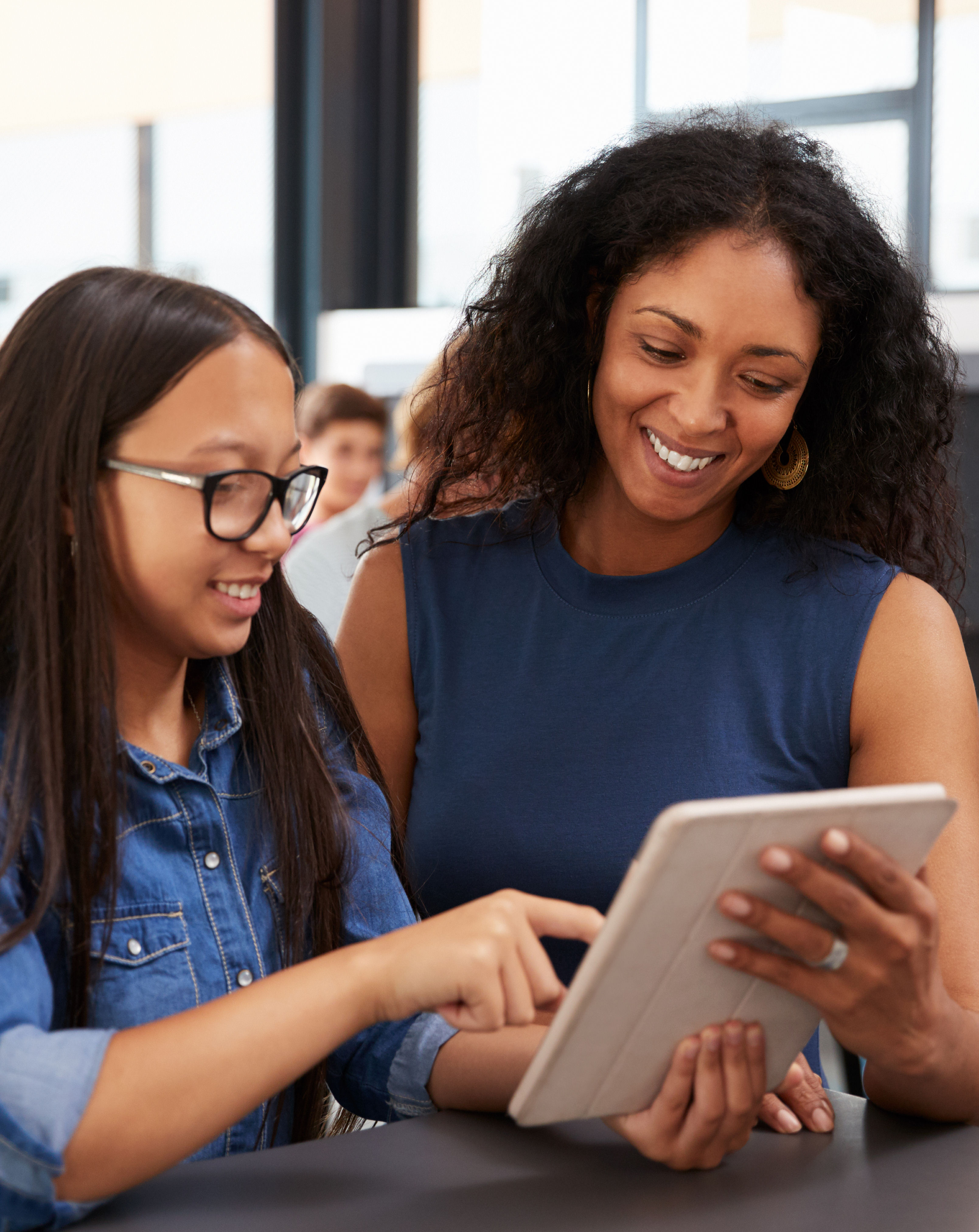 teacher and student viewing  webpage on a tablet