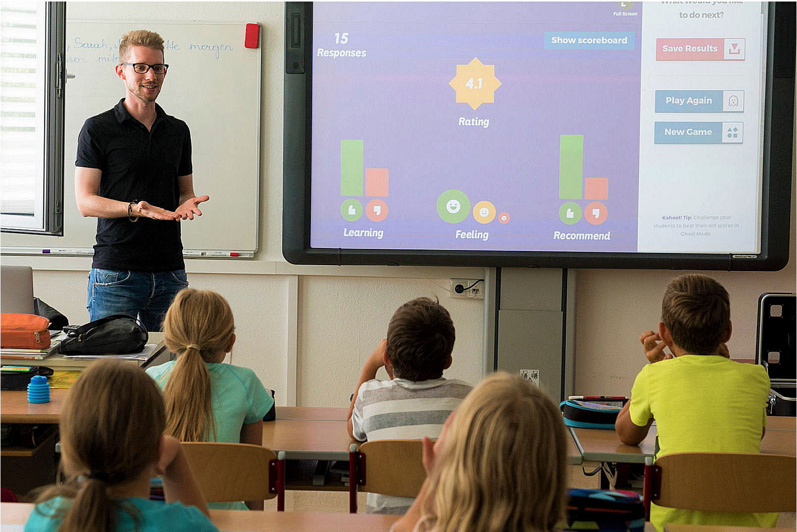 teacher playing a game with students using the whiteboard